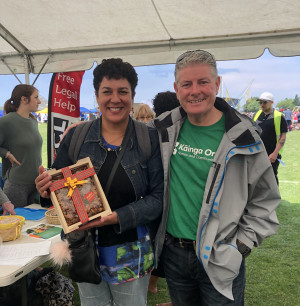 Winners are grinners … Kāinga Ora Area Manager Tim presents Cairo with a Christmas cake after she correctly guessed the number of cotton buds in a jar during the Affirm event.