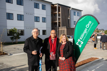 Three people standing infront of a development