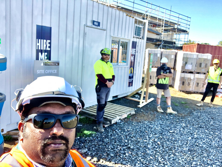Four men standing at a construction site.